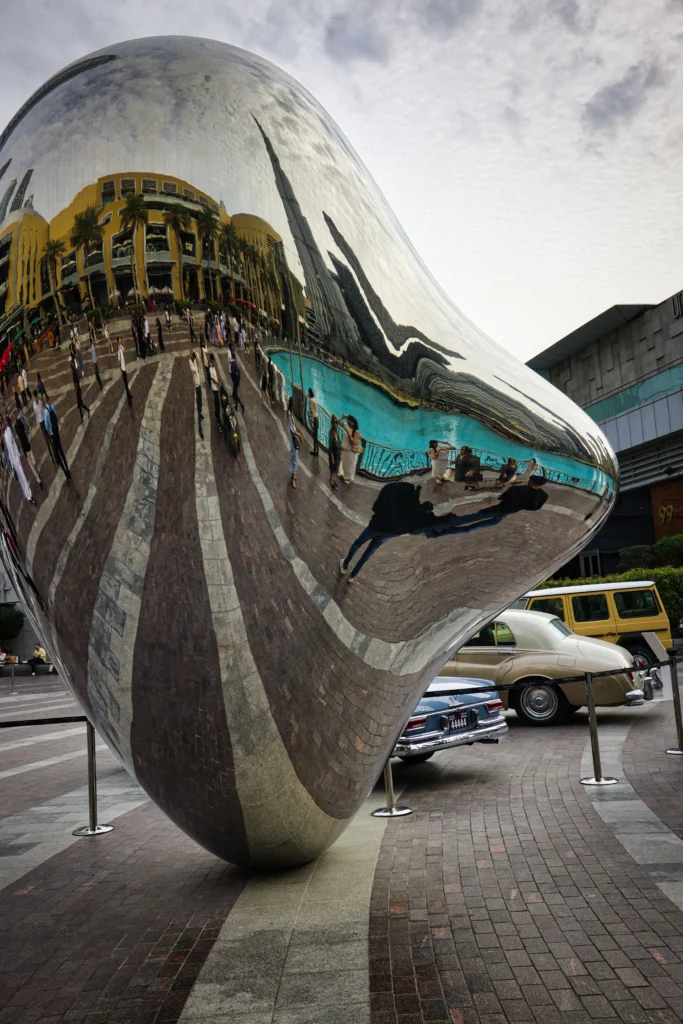 Burj Khalifa Reflected in Sculptural Mirror with Classic Cars – Dubai Mall Area