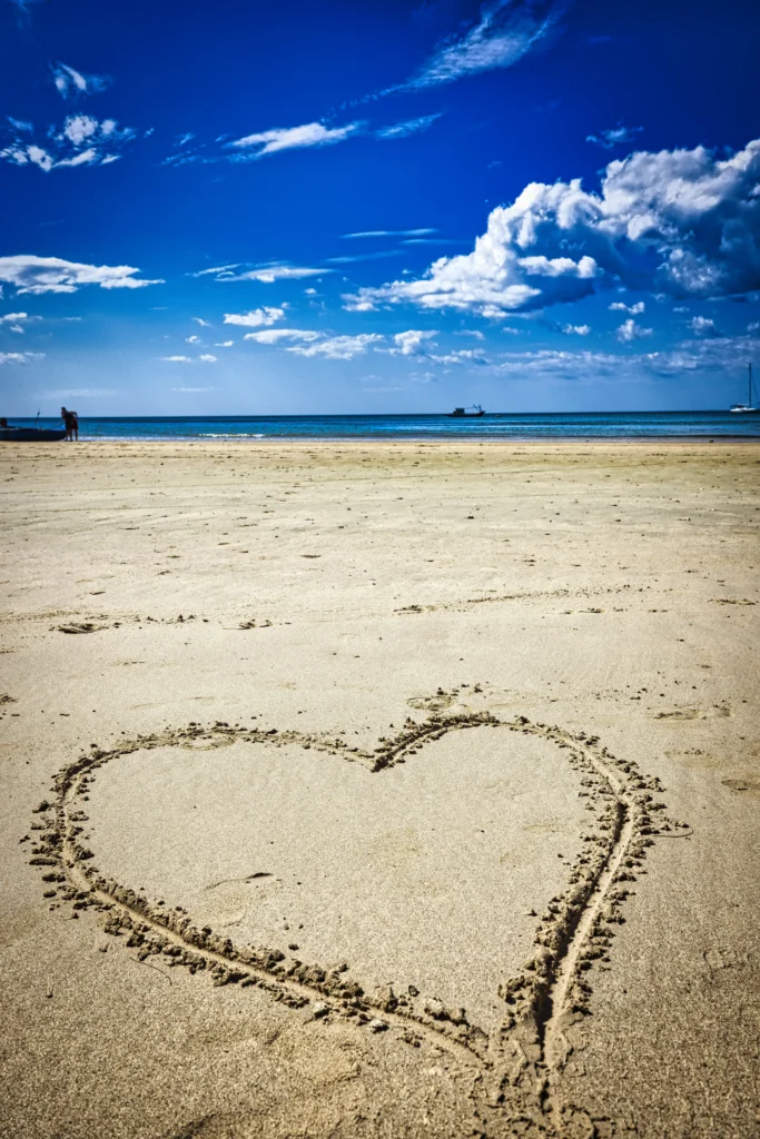 Heart Drawn on Beach Sand by the Ocean – Romantic Shoreline Scene