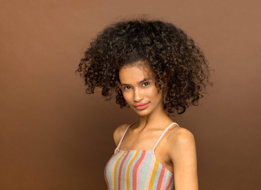 Portrait of a curly-haired girl — natural beauty in cinematic light by DICAPLO