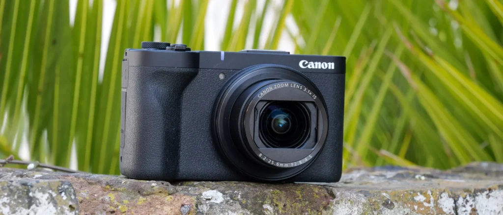 Canon PowerShot V1 held by content creator in outdoor vlog setup