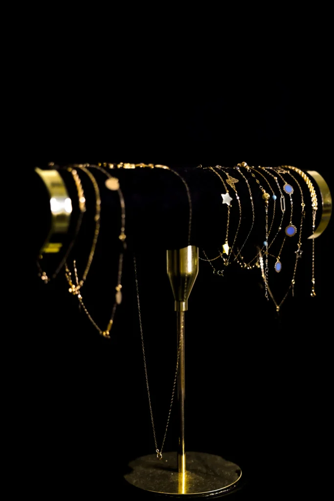 luxury gold jewelry display stand on black background — modern jewelry photography in Dubai Marina by Dicaplo Studio