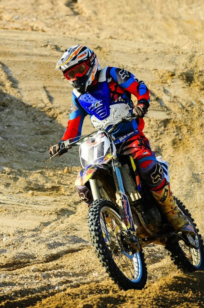 Professional motocross rider performing off-road action riding in Dubai desert captured with cinematic sports photography by Dicaplo Media.